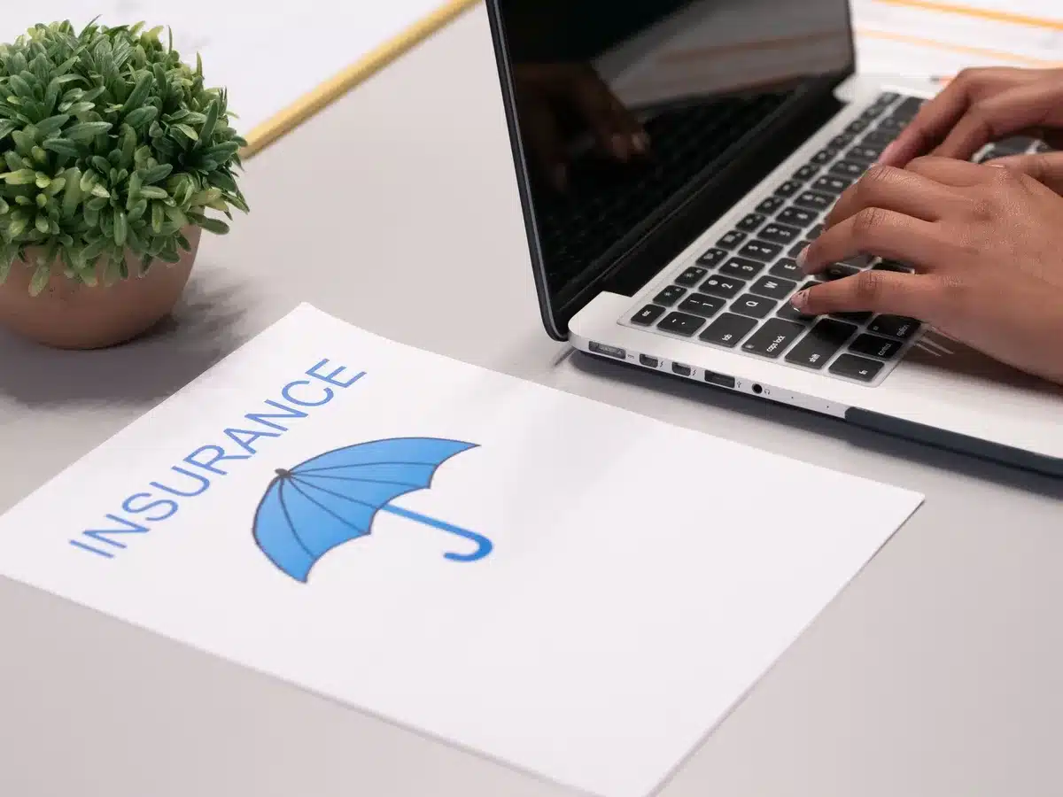 Ordinateur portable avec documents d'assurance voyage et formulaires