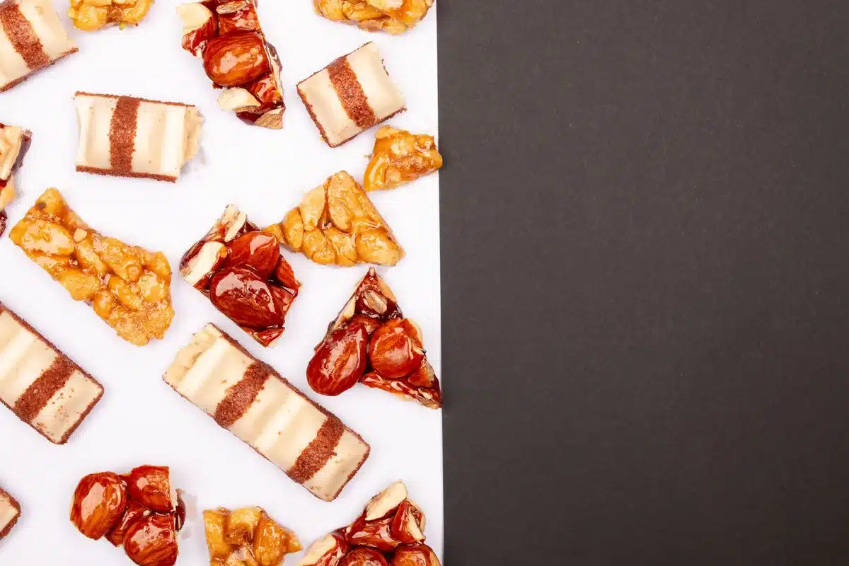 Découpe soignée du nougat en carrés réguliers d'environ 3 cm, prêts pour l'emballage individuel