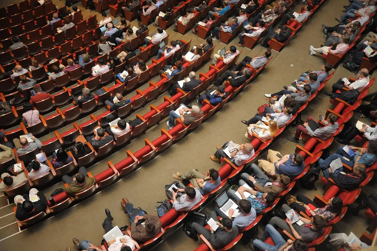 Personne consultant un programme devant des panneaux et des lieux culturels