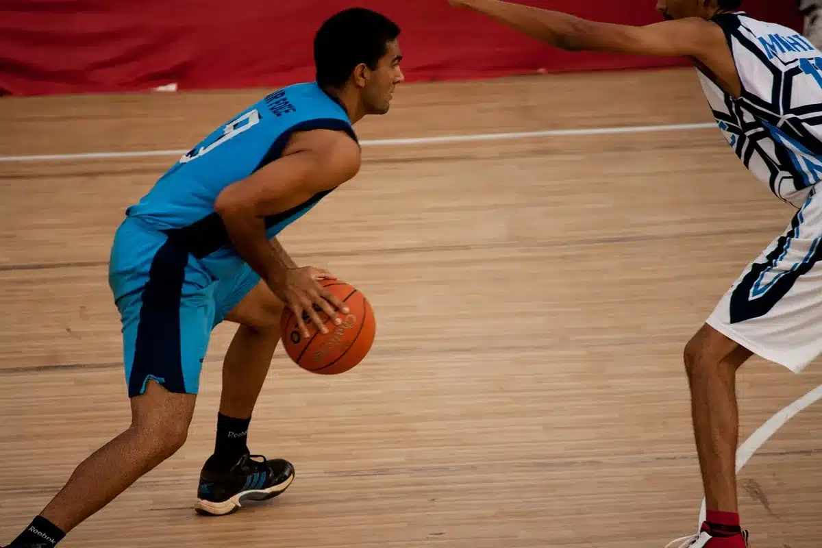 Action offensive pick-and-roll sur le parquet montrant un écran bas